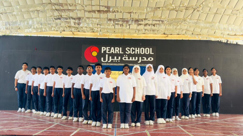 Grade 7 and 8 students receiving badges during Qatar Scouts & Guides Badging Ceremony