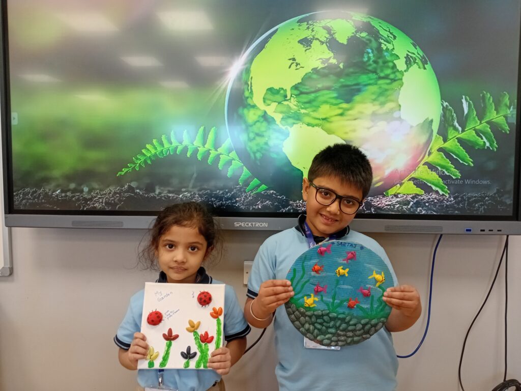 Students showcasing eco-friendly models during Earth Day Activity by grade 1-2