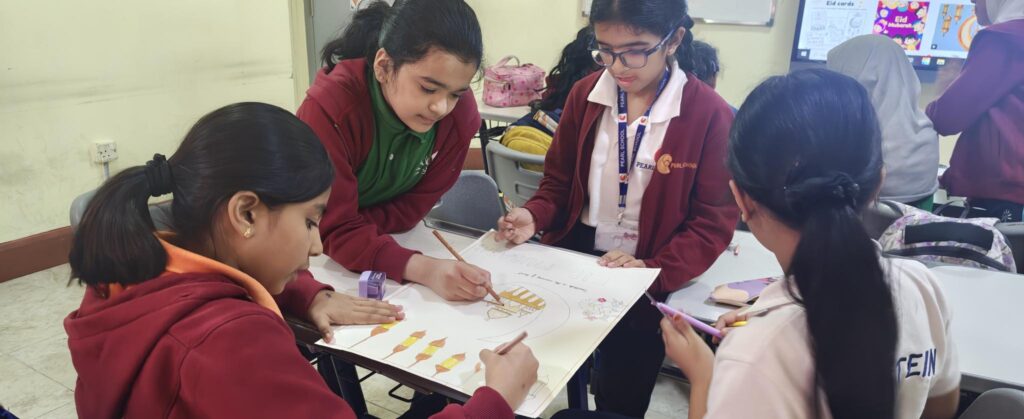 Students creating posters on togetherness during Eid Celebration Activity