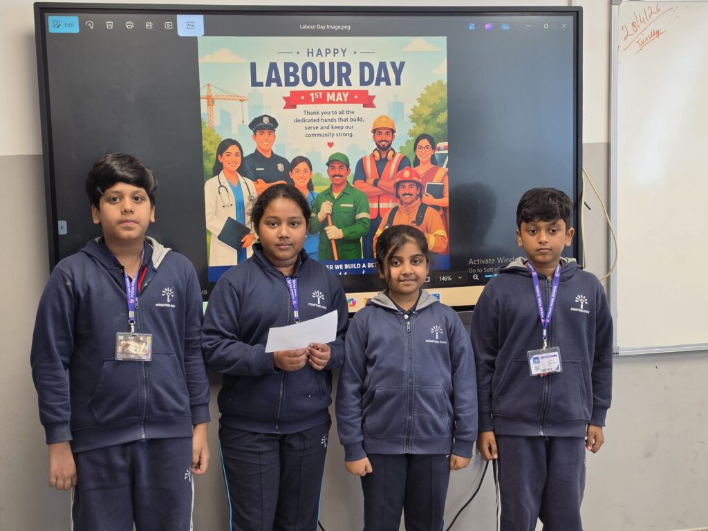 Grade 3–5 students participating in Labour Day activity with colouring and quiz