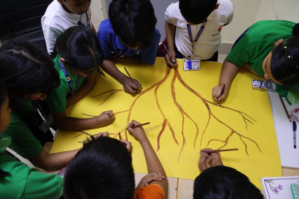 Students making Earth Promise Tree during Earth Day celebration at Pearl School