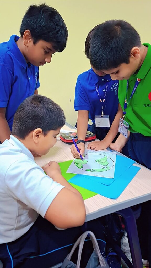 Students creating Earth Day crafts and posters at Pearl School Qatar